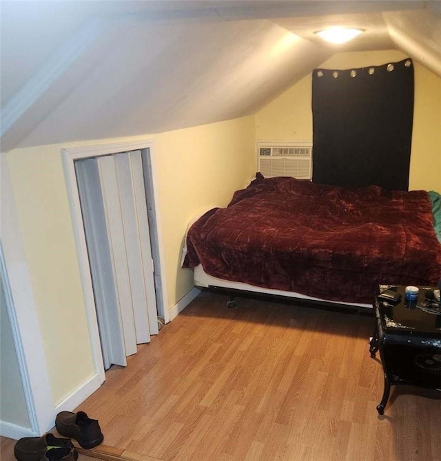 bedroom featuring light hardwood / wood-style flooring and vaulted ceiling