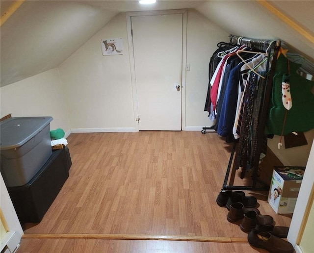 interior space with light hardwood / wood-style flooring and vaulted ceiling