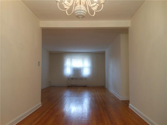861 Palisade Ave Unit 2D, Yonkers, NY 10703 - empty room featuring a chandelier, wood finished floors, and baseboards