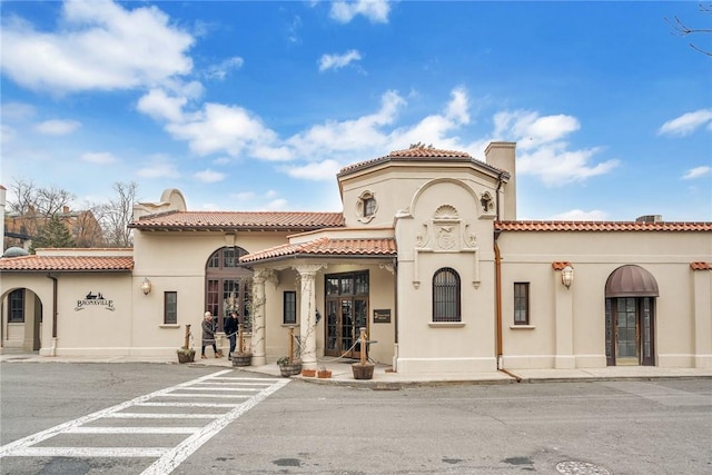 280 Bronxville Rd Unit 9B, Bronxville, NY 10708 - mediterranean / spanish-style house featuring stucco siding, a tile roof, and a chimney