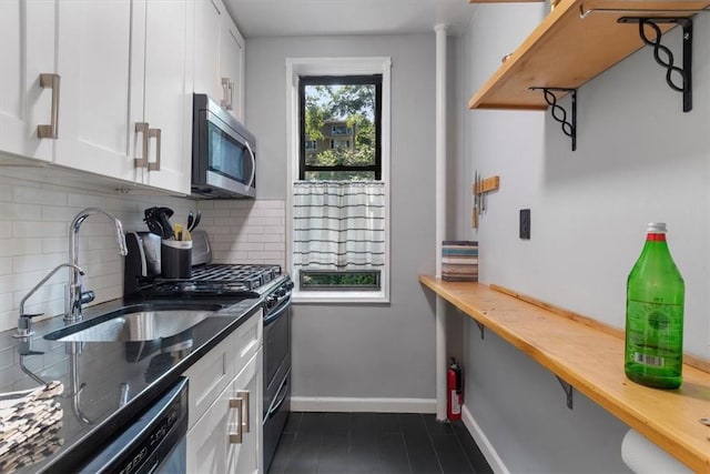 kitchen with appliances with stainless steel finishes, wooden counters, and white cabinets