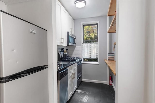 kitchen featuring tasteful backsplash, stainless steel appliances, white cabinets, and a healthy amount of sunlight