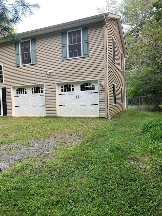 exterior space featuring a yard and a garage