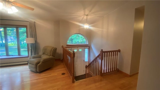 entrance foyer featuring ceiling fan, light hardwood / wood-style flooring, and a baseboard radiator