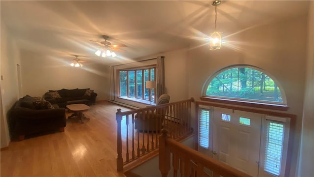 unfurnished living room with ceiling fan, light hardwood / wood-style flooring, and a healthy amount of sunlight