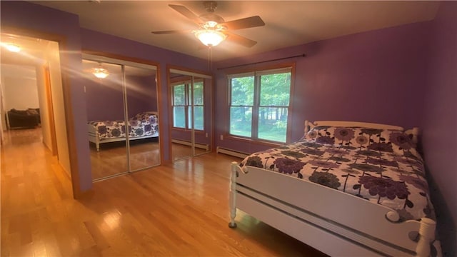 bedroom featuring hardwood / wood-style floors, a baseboard radiator, and ceiling fan