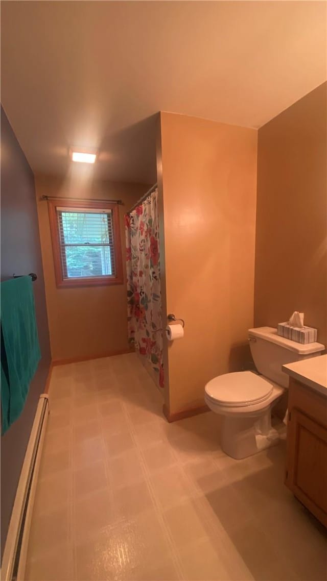 bathroom with vanity, toilet, walk in shower, and a baseboard heating unit