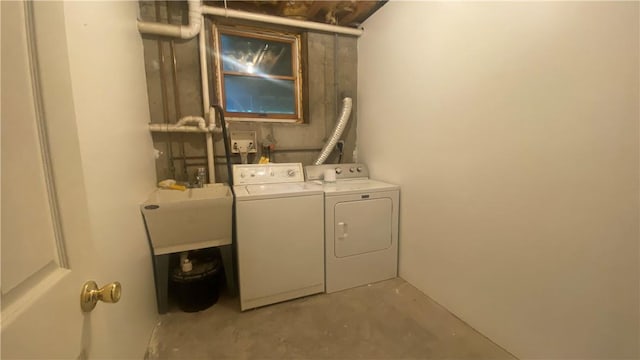 washroom with separate washer and dryer and sink