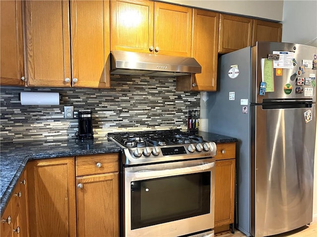 kitchen with dark stone countertops, decorative backsplash, and appliances with stainless steel finishes