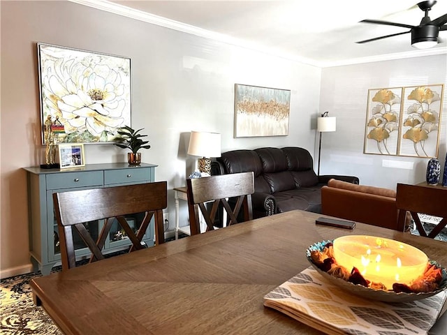 dining space with ceiling fan and ornamental molding