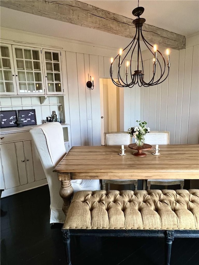 dining room with beam ceiling and an inviting chandelier