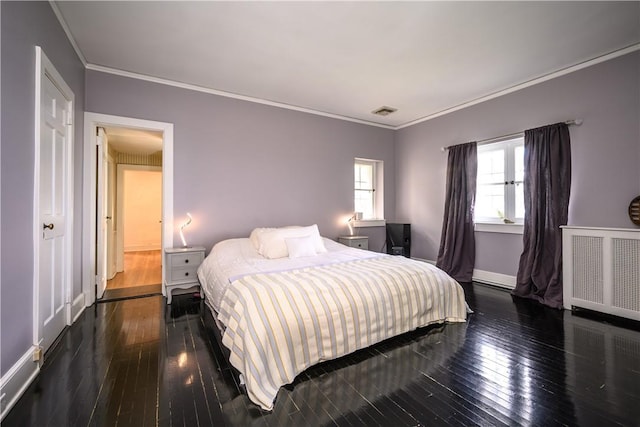 bedroom featuring crown molding, radiator, and dark wood-type flooring