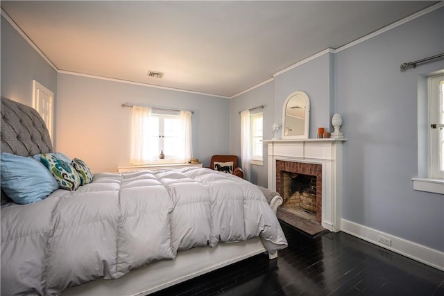 bedroom with a fireplace, hardwood / wood-style flooring, and ornamental molding