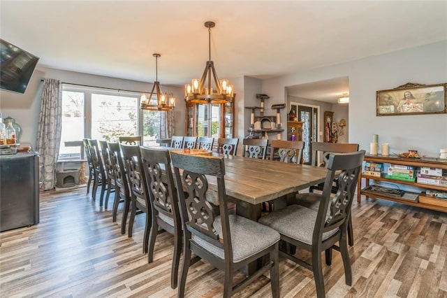 dining area featuring light wood-type flooring and a chandelier