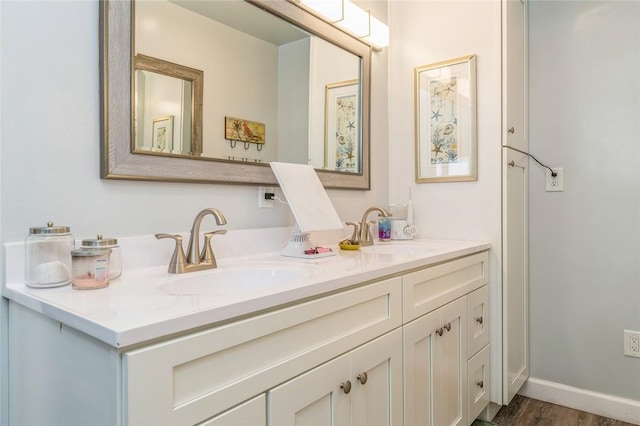 bathroom with vanity and hardwood / wood-style flooring