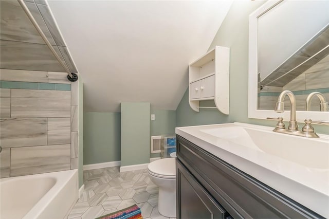 bathroom featuring tile patterned floors, vanity, toilet, and vaulted ceiling