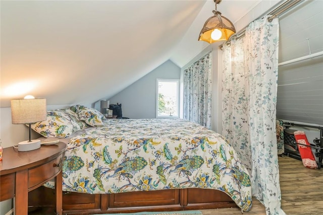 bedroom featuring hardwood / wood-style flooring and vaulted ceiling