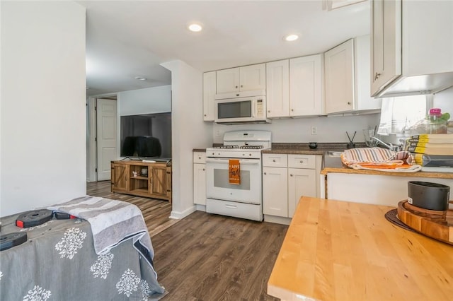 kitchen with white cabinets, dark hardwood / wood-style floors, butcher block counters, and white appliances