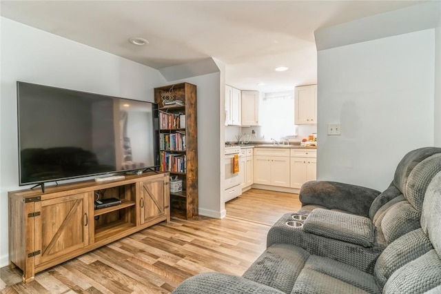 living room featuring light hardwood / wood-style flooring and sink