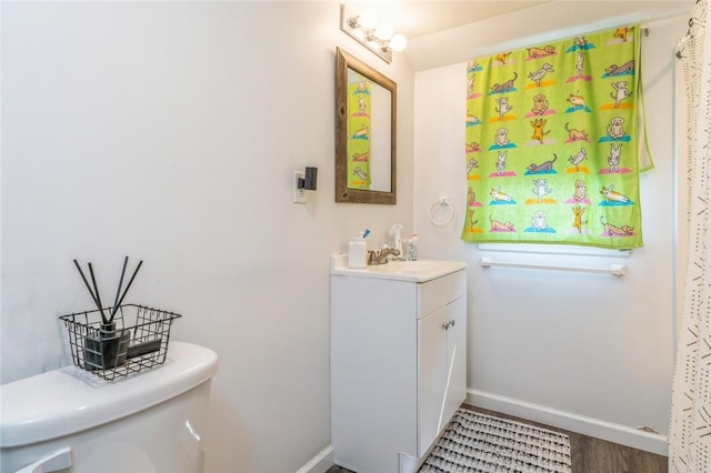 bathroom featuring hardwood / wood-style floors, vanity, and toilet