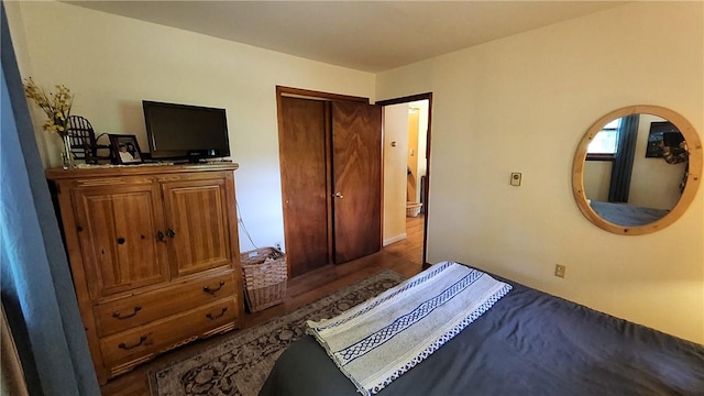 bedroom featuring dark hardwood / wood-style floors and a closet