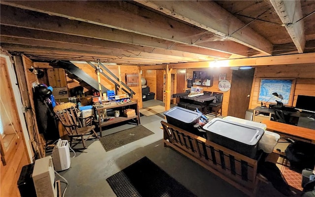 basement featuring wooden walls