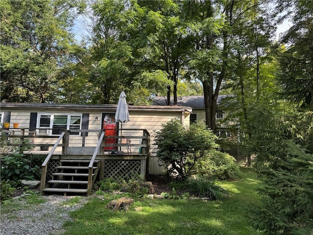 view of front of home featuring a front lawn and a deck