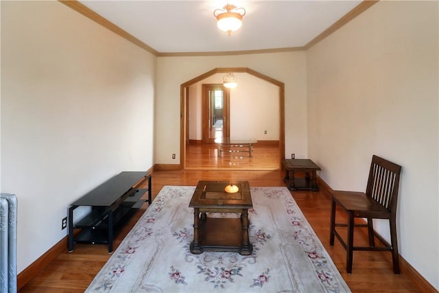 living room with hardwood / wood-style floors and ornamental molding