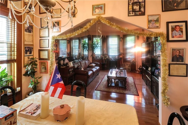 living room with hardwood / wood-style floors and a notable chandelier