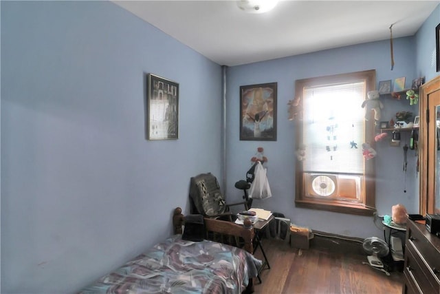 bedroom with dark hardwood / wood-style floors