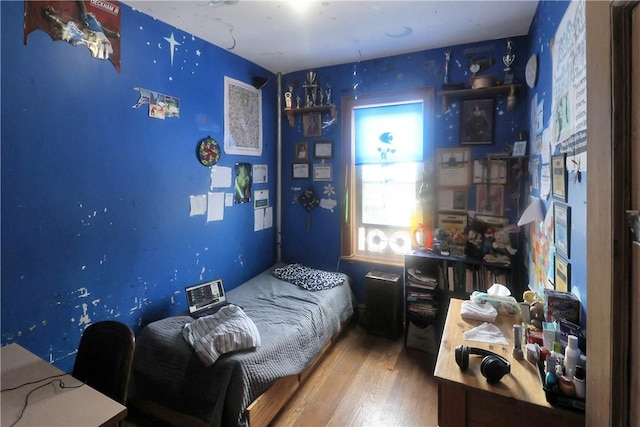 bedroom with hardwood / wood-style floors