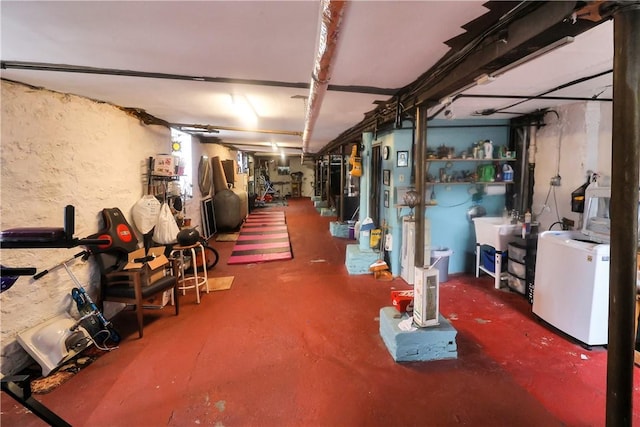 basement featuring washer / dryer and sink