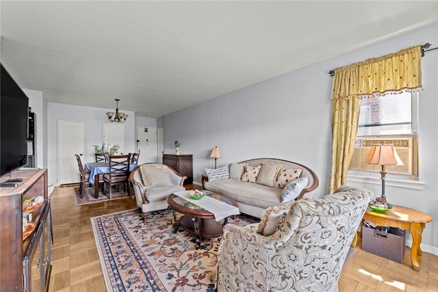 living room featuring cooling unit, parquet floors, and a chandelier