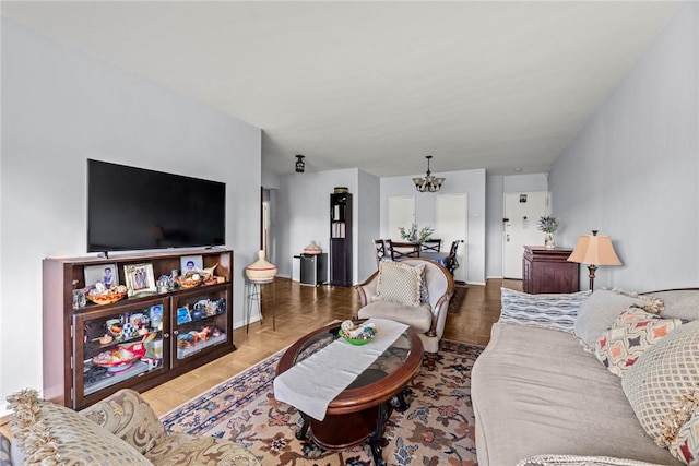 living room featuring wood-type flooring and a notable chandelier