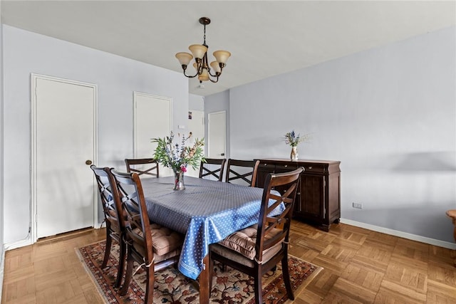 dining room with parquet flooring and an inviting chandelier