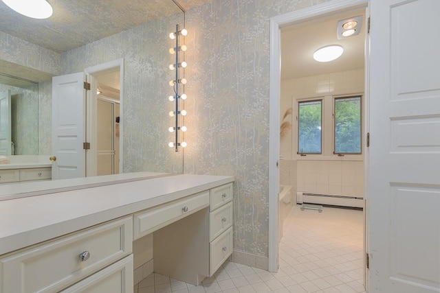 bathroom featuring vanity, bathing tub / shower combination, tile patterned floors, and baseboard heating