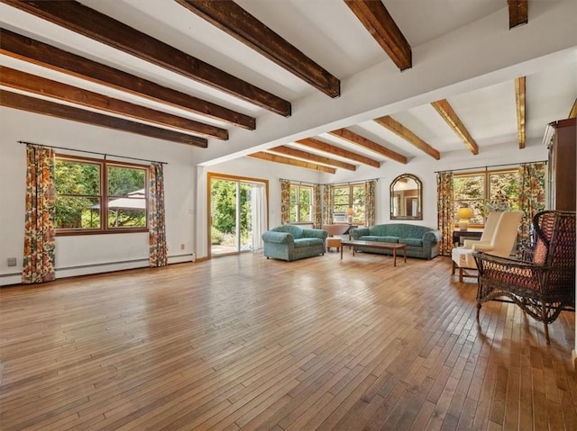 interior space with beamed ceiling, a baseboard radiator, and light hardwood / wood-style flooring