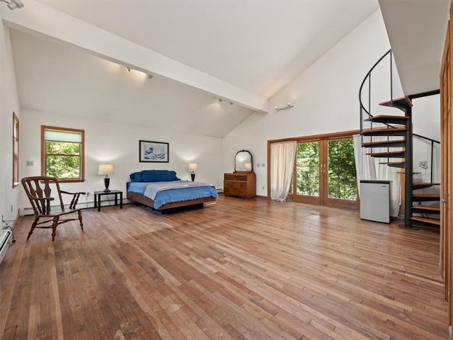 bedroom featuring track lighting, beam ceiling, high vaulted ceiling, and light hardwood / wood-style flooring