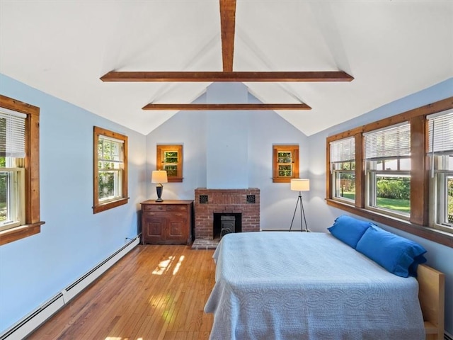 bedroom with lofted ceiling with beams, light hardwood / wood-style floors, a fireplace, and a baseboard heating unit