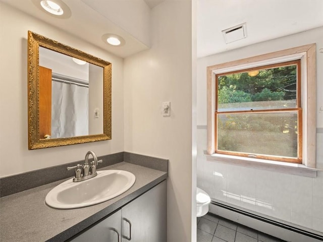 bathroom featuring tile patterned floors, vanity, toilet, and baseboard heating