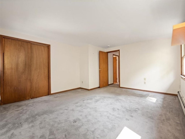 unfurnished bedroom with a closet and light colored carpet