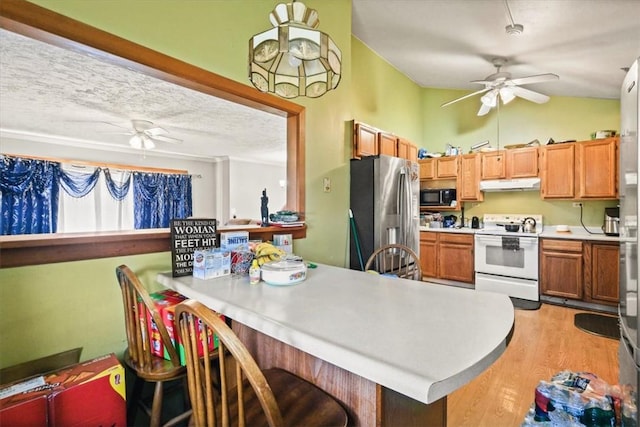 kitchen with stainless steel fridge, a textured ceiling, vaulted ceiling, electric stove, and light hardwood / wood-style flooring