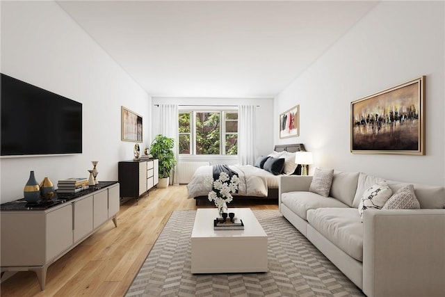 bedroom with radiator heating unit and light hardwood / wood-style floors