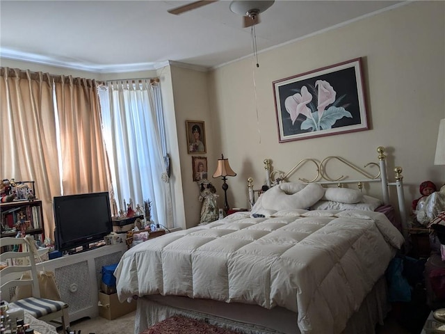 bedroom featuring ceiling fan and ornamental molding