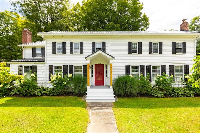 colonial-style house with a front yard