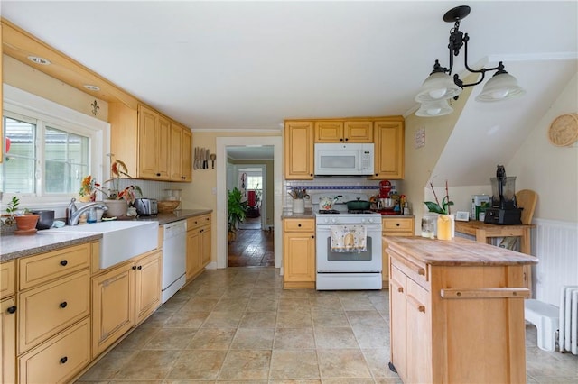 kitchen with backsplash, white appliances, sink, light brown cabinets, and hanging light fixtures