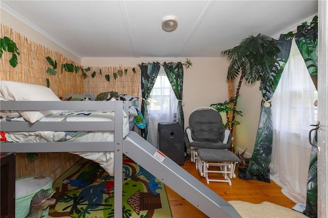 bedroom featuring crown molding and wood-type flooring