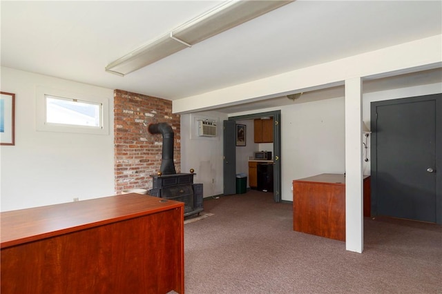 unfurnished living room featuring a wall mounted air conditioner, a wood stove, and light carpet