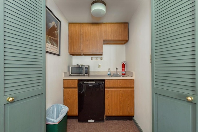 kitchen featuring dark colored carpet, sink, and black dishwasher