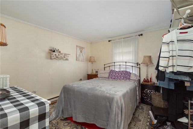 bedroom with ornamental molding and baseboard heating